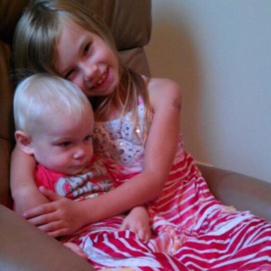 His big sister, Grace, loves him so much... and he really enjoys snuggling with her.  Here, he is using her skirt as a blanket. :)