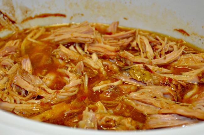 Slow Cooker Pulled Pork for a Crowd - Shred the Pork after cooking - Just 5 Ingredients from JennsRAQ.com
